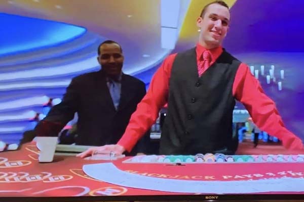 smiling card dealer in a casino